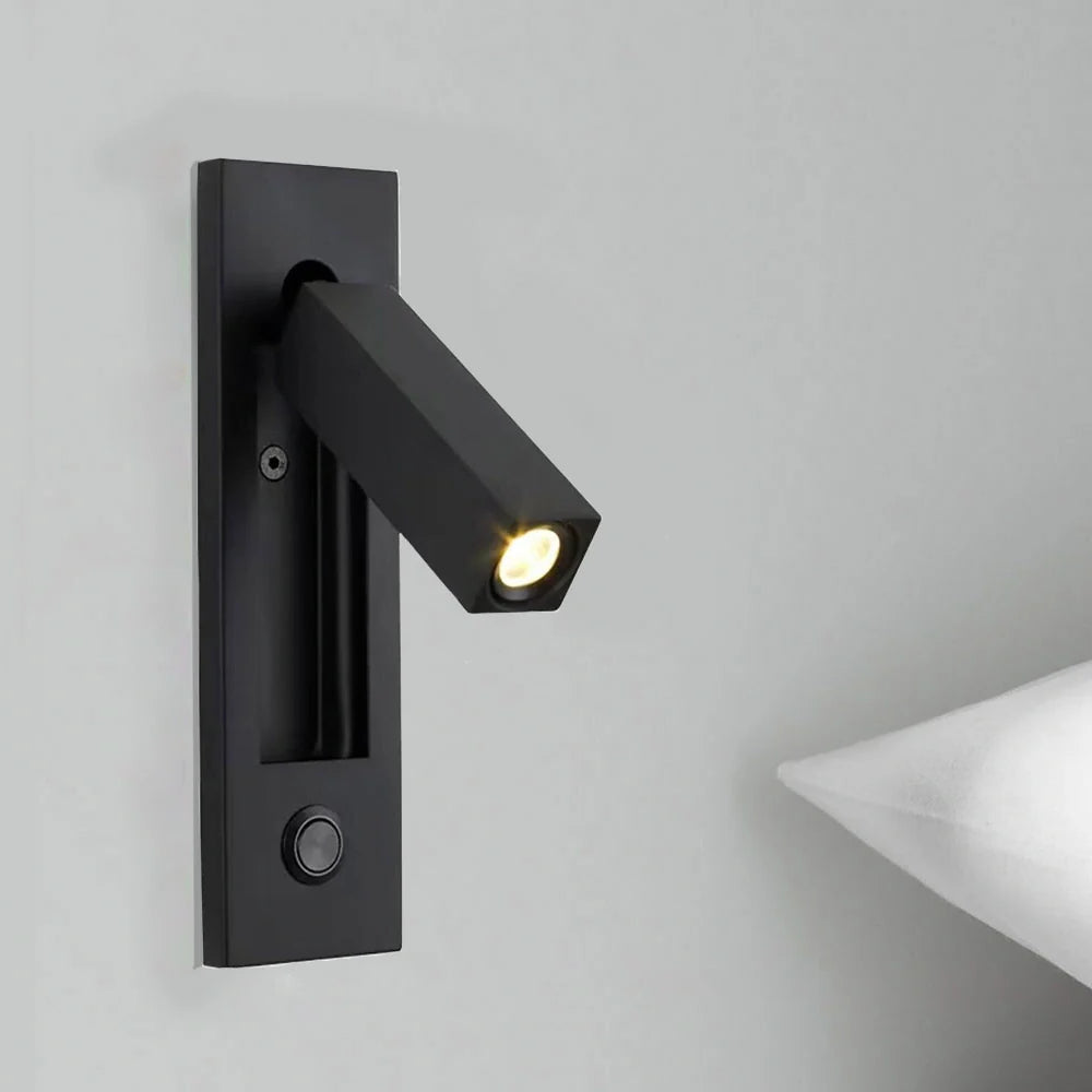 Black wall-mounted light fixture on a gray wall