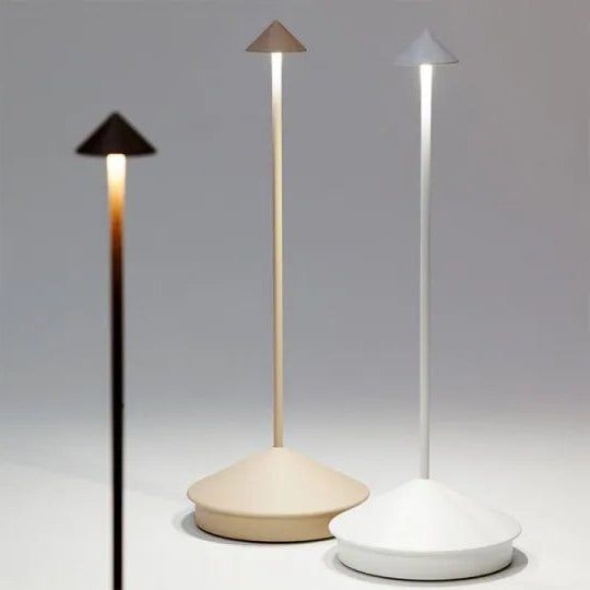 Three modern outdoor lamps with different shades of light on a gray background