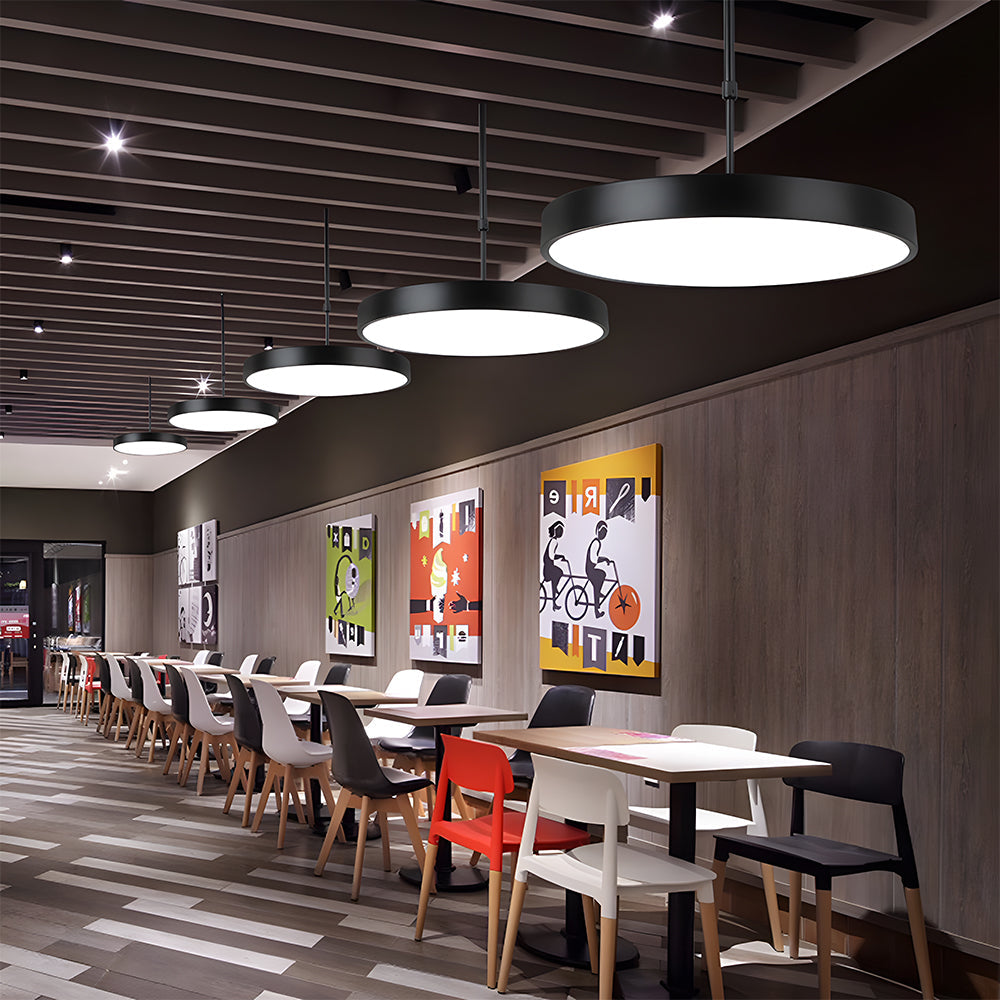 Modern restaurant interior with tables, chairs, and decorative wall art.