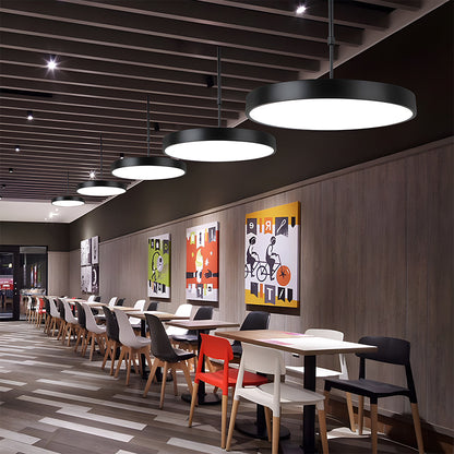 Modern restaurant interior with tables, chairs, and decorative wall art.