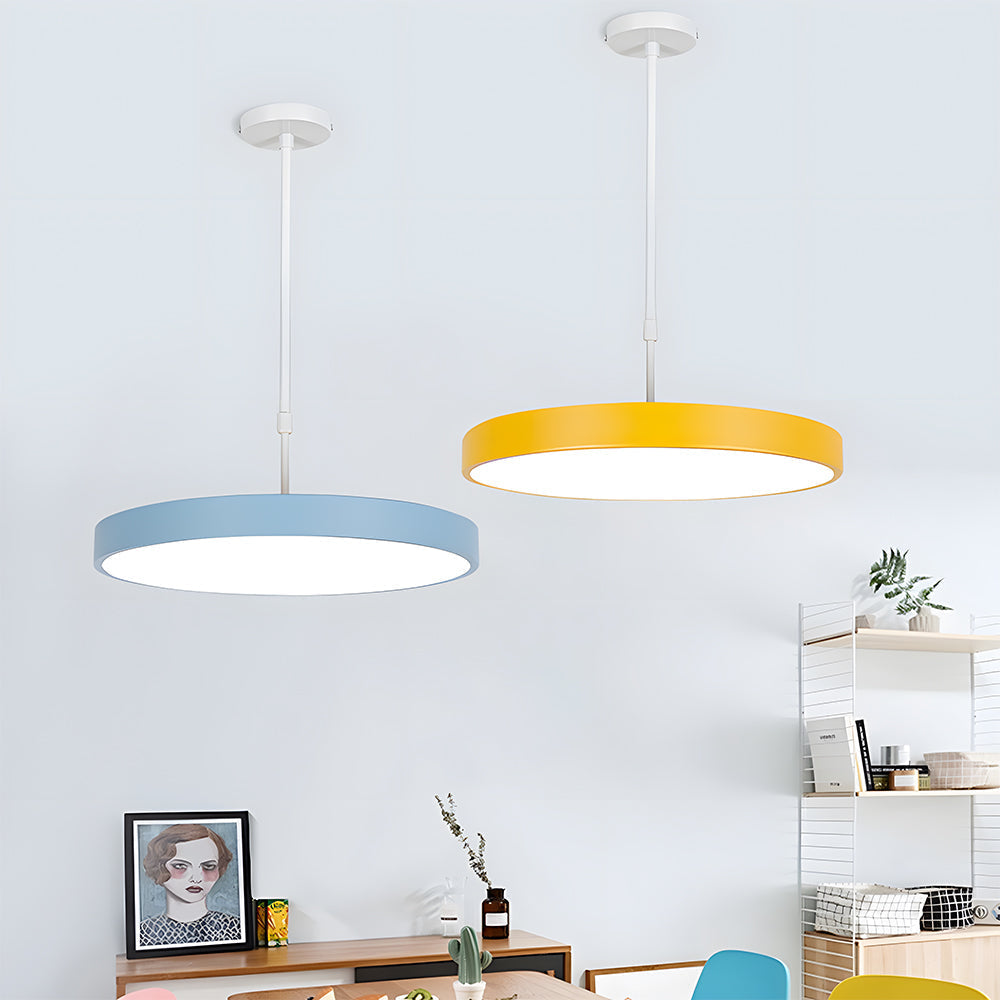 Two colorful pendant lights hanging in a room with shelves and decor.