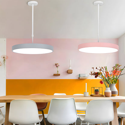Modern dining room with pink and yellow walls, wooden table, and white chairs.