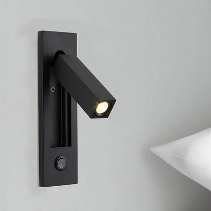 Black wall-mounted light fixture on a gray wall