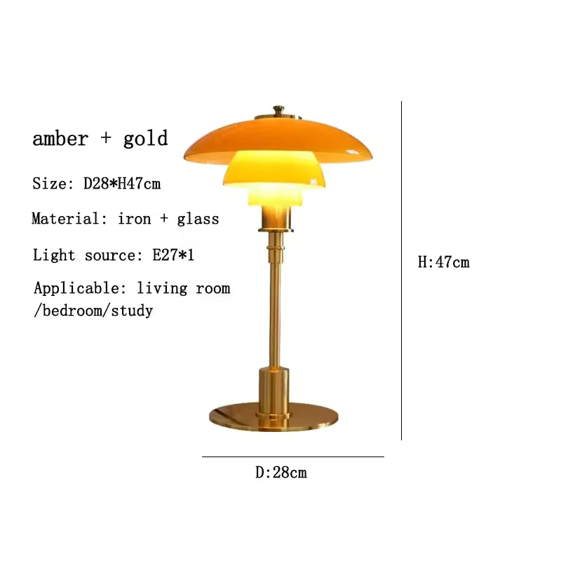 Table lamp with amber glass shade and gold base, featuring dimensions and material details.