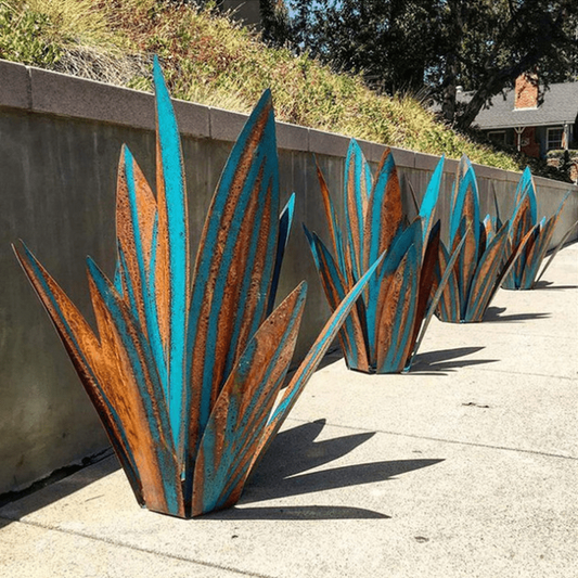 Decorative Garden light metal planters with blue and rust finish on a sidewalk.