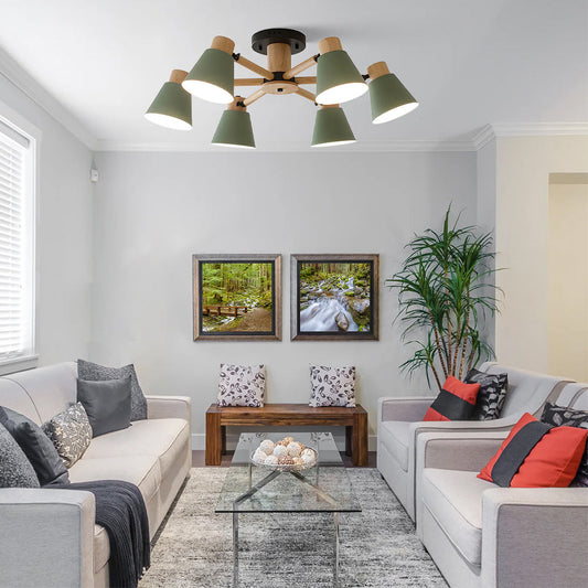 Living room with modern decor, including a chandelier, couches, and framed pictures.