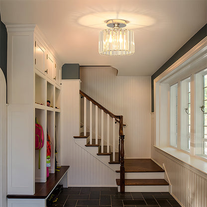 Staircase with wooden railings and a modern light fixture in a home interior.