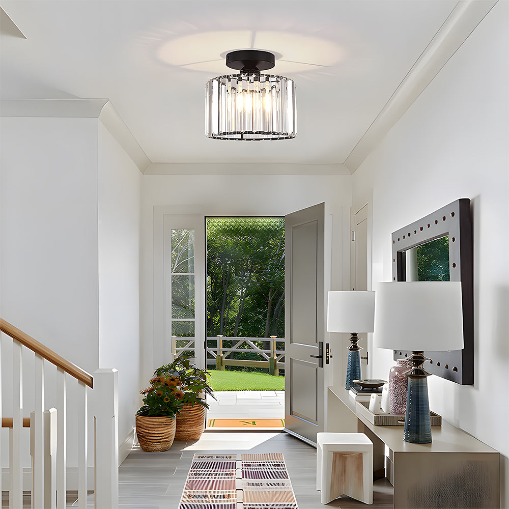 Modern home interior with a ceiling light fixture, mirror, and decorative elements.