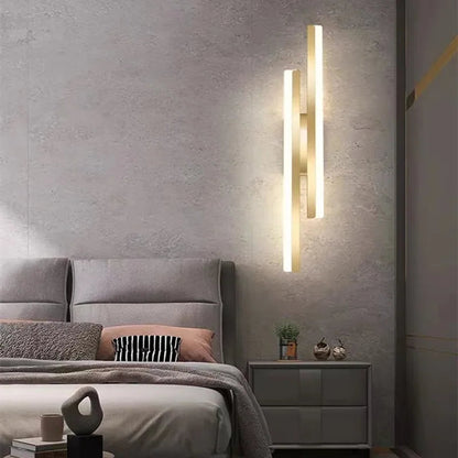 Modern bedroom with a wall-mounted light fixture, bed, and nightstand.