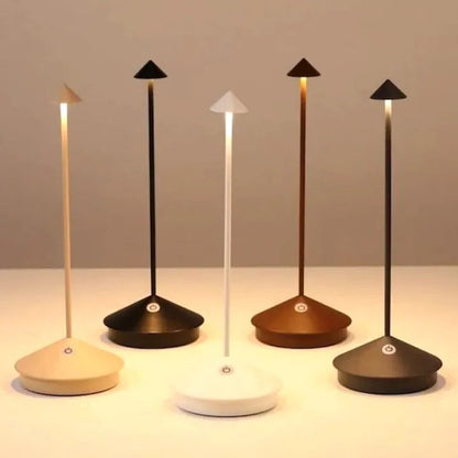 Set of five modern desk lamps with different base colors on a neutral background