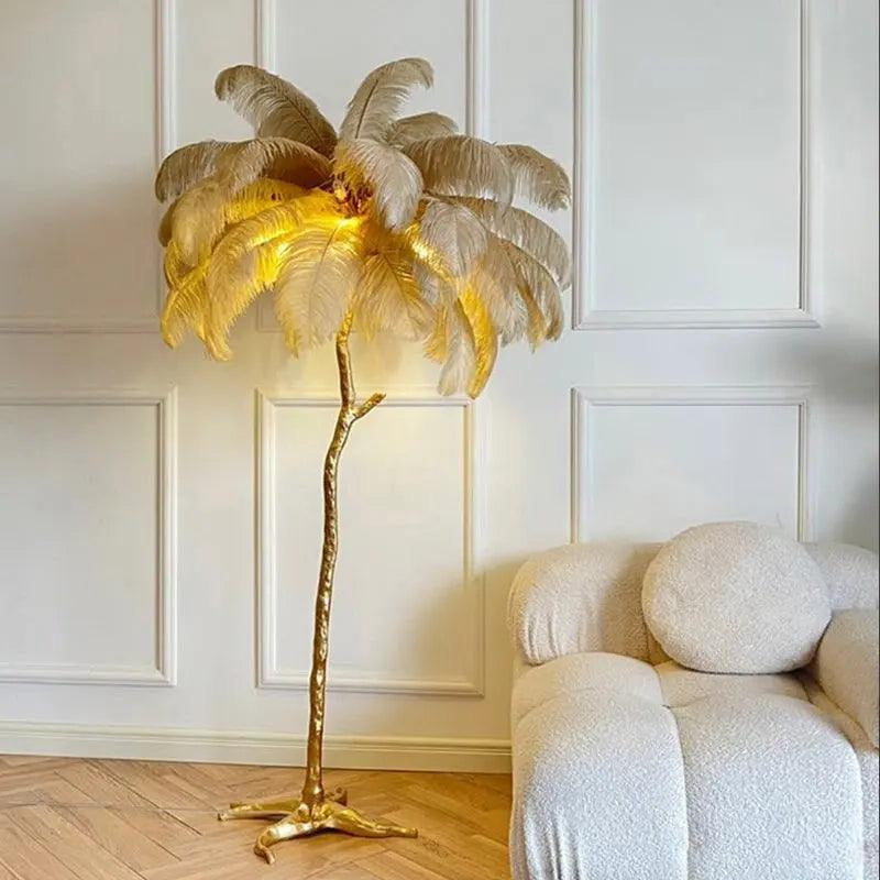 Gold palm tree floor lamp in a room with white walls and a white armchair.